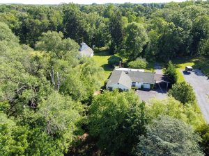 Aerial drone view of a Florence NJ property surrounded by trees and open space showing privacy and large lot layout