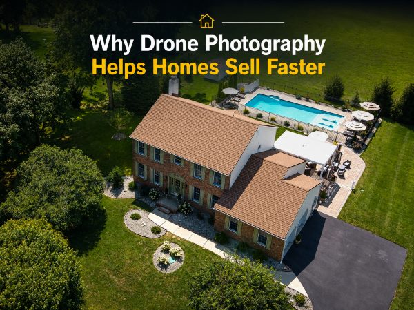 Aerial drone view of a luxury brick home with backyard pool, patio, and expansive property showcasing the benefits of drone photography in real estate marketing