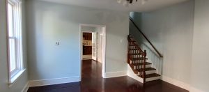 Living room with hardwood floors and staircase in Roebling NJ home