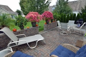 Backyard patio in Hamilton NJ with seating area, pavers, and landscaped surroundings
