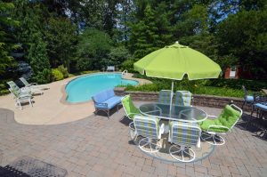 Backyard in Hamilton NJ with inground pool, patio, and outdoor seating area