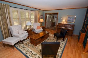 Formal living room in Hamilton NJ with hardwood floors, shutters, and traditional layout