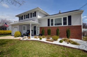 Covered front porch entry in Hamilton NJ with seating and decor