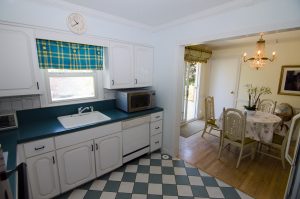 Older kitchen and dining area in Hamilton NJ home showing traditional layout and dated finishes