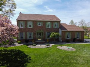 Brick colonial home in Hamilton Township NJ with landscaped front yard and strong curb appeal