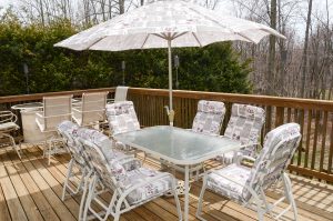 Backyard deck in Hamilton Township NJ with seating and wooded view