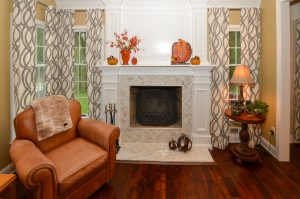 Fireplace in Hamilton Township NJ home with decorative trim work, custom mantel, and detailed tile surround