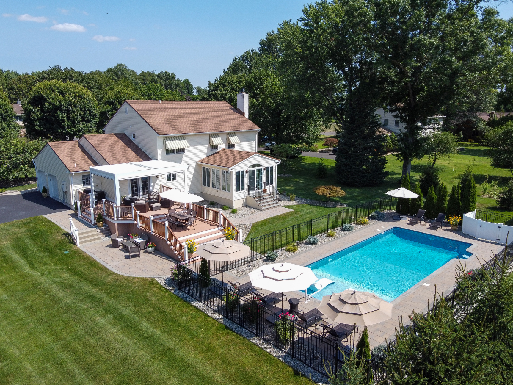 Aerial view of backyard with inground pool and outdoor living space in Hamilton NJ