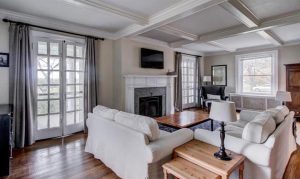 Living room in Roebling NJ home with coffered ceiling, fireplace, and hardwood floors