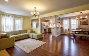 Open concept living room and kitchen in Robbinsville NJ with hardwood floors, natural light, and clean, well-presented layout