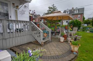 Outdoor patio and backyard living space behind historic homes in Roebling NJ