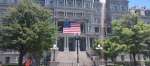 American flag displayed outside a historic government building in Washington DC during America's 250th anniversary celebration