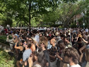 Community members gathered outdoors during a neighborhood event celebrating connection and shared experiences