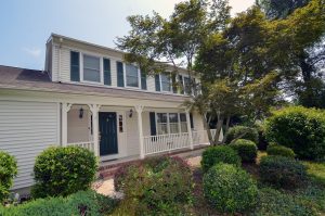 Colonial home in Hamilton NJ with covered front porch, mature landscaping, and strong curb appeal