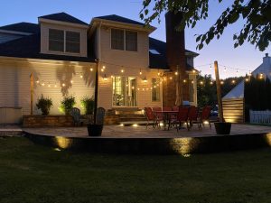 Backyard patio illuminated by string lights on a summer evening in New Jersey
