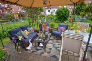 Covered backyard patio seating area at a home in Roebling NJ designed for relaxing and gathering with family and friends