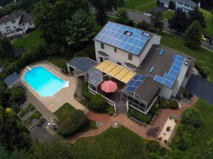 Aerial view of residential rooftop solar panel installation in New Jersey