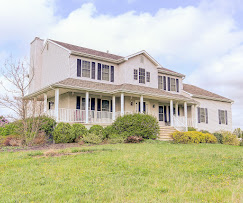 Well-maintained Colonial home with attractive landscaping in Columbus NJ, illustrating the type of home serious buyers continue searching for during the fall market.