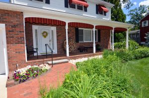 Brick walkway leading to the covered front porch of a Hamilton NJ home, representing the first step in a real estate conversation