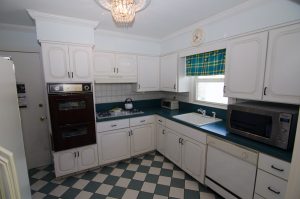 Kitchen with original cabinets, laminate countertops, and functional layout in a well-maintained Hamilton NJ home