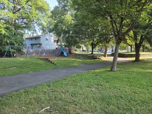 Walking path, playground, swings, benches, and mature trees at Periwinkle Park in Hamilton Township NJ.