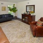 Living room with natural light, hardwood floors, comfortable seating, and an open layout in a Hamilton NJ colonial home.