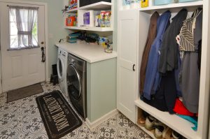 Mudroom and laundry room in a Hamilton NJ home featuring built-in storage, coat hooks, cubbies, and first-floor laundry.