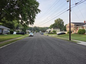 Established residential street in Hamilton Square NJ featuring mature trees, sidewalks, and well-maintained homes.