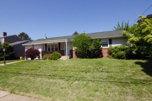 Single-story ranch home in Hamilton Square NJ with a covered front porch and established landscaping.