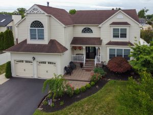 Larger two-story home with attached two-car garage in a Hamilton Township NJ residential neighborhood.