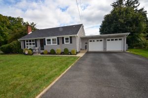 Split-level home in Hamilton NJ with attached two-car garage, landscaped front yard, and established residential setting.