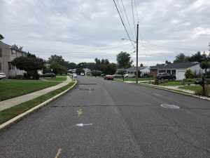 Residential street in the Sunnybrae section of Yardville NJ lined with established ranch homes, sidewalks, and mature neighborhood landscaping.