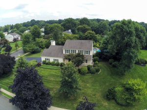 Aerial view of a large colonial home with mature landscaping and surrounding homes in Washington Square in Yardville, Hamilton Township NJ.