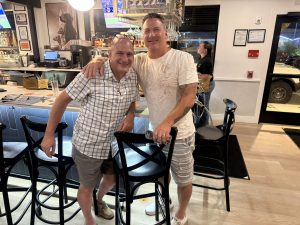 Philip Angarone standing with Doug Hunt inside a restaurant during the client journey for Doug and Angelina Hunt in Hamilton Township NJ.